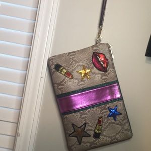 A snakeskin ALDO cosmetic bag / case .